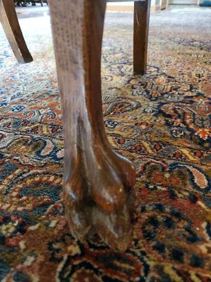 Vintage oak dining chair featuring paw feet, fan shaped pattern on upholstered seat, and slatted back design.