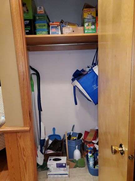 Hall closet contents includes Swiffer wet mop cloths and dry mop cloths, Swiffer mops, magic erasers, latex gloves, garbage bags, O-Cedar broom and dustpan, Swiffer mops, bona wood floor mop, scrub brushes, nitrile gloves, assorted cleaners, gift bag tissue paper, cleaning buckets, cloth bags. See photos