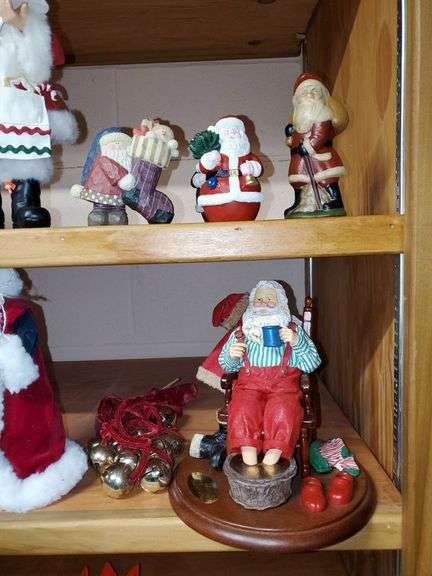 Lot of holiday items including decorative pewter-like angel figures, candle holder, ceramic Christmas manger, Santa Claus figurines, Santa Claus cookie jar, Christmas bells.