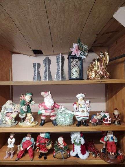 Lot of holiday items including decorative pewter-like angel figures, candle holder, ceramic Christmas manger, Santa Claus figurines, Santa Claus cookie jar, Christmas bells.