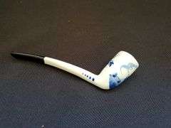 Delft blue bisque water boy figurine, pipe and collectors pieces 7 book