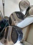 Spalding nylon golf bag with assorted drivers, sand wedge and putter. Includes two pairs of size 8 golf shoes by Ecco and FootJoy. See photos.