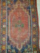Hand knotted rug featuring center medallion and floral border. Measures 31-in x54 in.