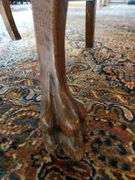 Vintage oak dining chair featuring paw feet, fan shaped pattern on upholstered seat, and slatted back design.