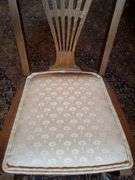 Vintage oak dining chair featuring paw feet, fan shaped pattern on upholstered seat, and slatted back design.