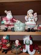 Lot of holiday items including decorative pewter-like angel figures, candle holder, ceramic Christmas manger, Santa Claus figurines, Santa Claus cookie jar, Christmas bells.