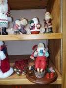 Lot of holiday items including decorative pewter-like angel figures, candle holder, ceramic Christmas manger, Santa Claus figurines, Santa Claus cookie jar, Christmas bells.