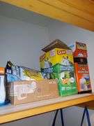 Hall closet contents includes Swiffer wet mop cloths and dry mop cloths, Swiffer mops, magic erasers, latex gloves, garbage bags, O-Cedar broom and dustpan, Swiffer mops, bona wood floor mop, scrub brushes, nitrile gloves, assorted cleaners, gift bag tissue paper, cleaning buckets, cloth bags. See photos