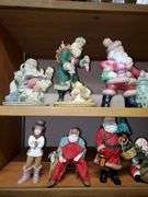 Lot of holiday items including decorative pewter-like angel figures, candle holder, ceramic Christmas manger, Santa Claus figurines, Santa Claus cookie jar, Christmas bells.