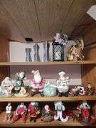 Lot of holiday items including decorative pewter-like angel figures, candle holder, ceramic Christmas manger, Santa Claus figurines, Santa Claus cookie jar, Christmas bells.