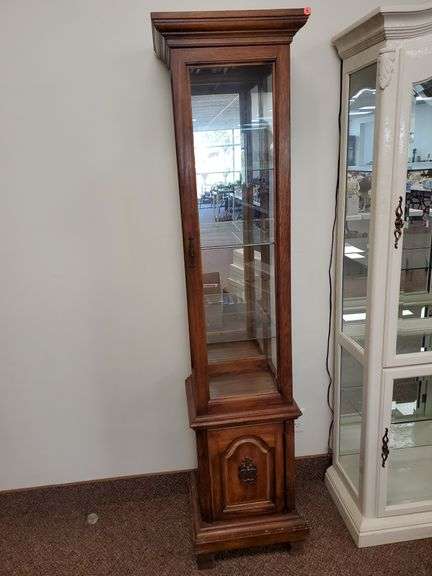 Solid wood illuminated mirrored back Curio cabinet with lower storage, three glass shelves and measures 16 in w x 14 in D x 72 in H.