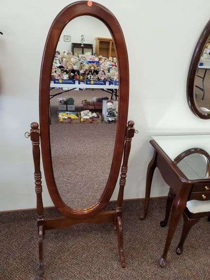Solid wood cheval floor mirror measures 60 in H X 25 in w.