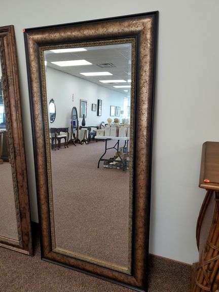 Bevel edged wall mirror features outer distressed metal like frame with inner gold patterned border. Measures 36 in wide X 69 in tall.