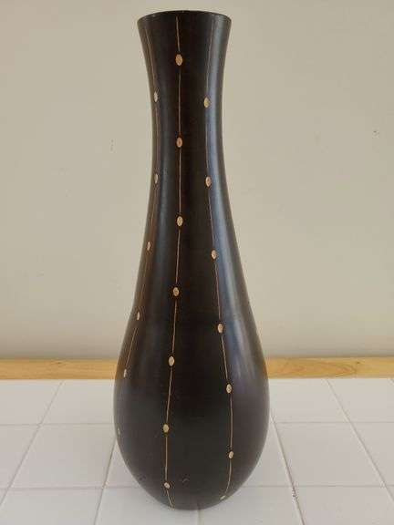 19-in tall dark finish wood vase with carved accents.