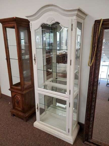 Traditional design illuminated Curio cabinet features beveled glass doors, decorative brass pulls, wood accents, four glass shelves and measures 30 in W x 14 in D X 76 in H. See photos