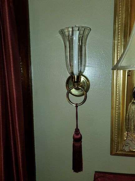 Pair of brass wall sconces with globes and LED candles