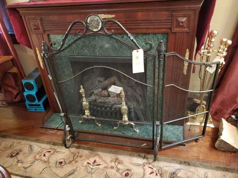 Black trifold fireplace screen with glass center medallion