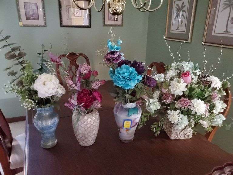 Ornate ceramic vases with artificial arrangements.