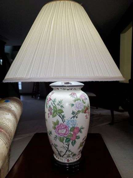 Ceramic lamp with raised floral design and pleated fabric shade stands 24 in tall. Living room