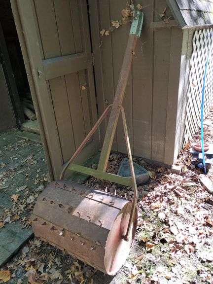 Tow behind lawn aerator/roller. Behind shed two. Heavy item. Bring trailer to load.