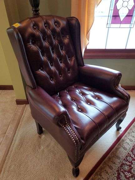 Pair of armchairs with burgundy faux leather upholstery, brass-like button accents, tufted seats and Queen Anne legs. See photos. Living room