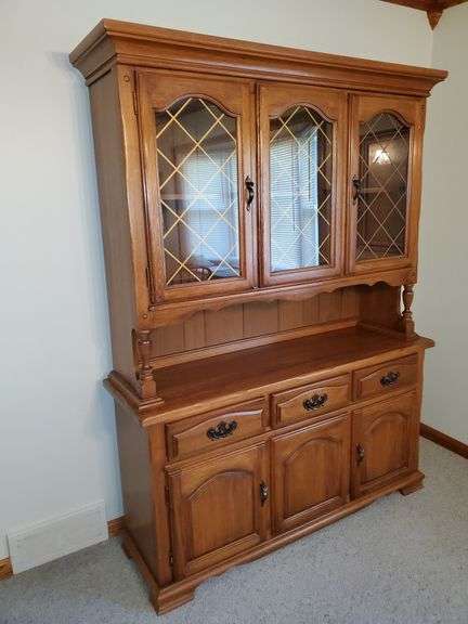 Solid wood china cabinet with brass hardware measures 58 in W x 17 in D X 77 in H. Very nice condition.