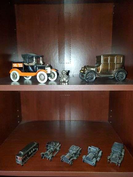 Ertyl diecast replica 1918 model t, cast iron car bank, small cast iron replica cars. Living room