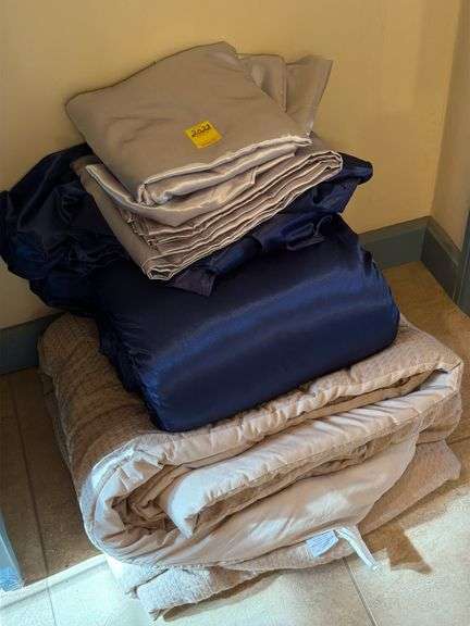 Satin silver queen sheet set, satin queen sheet set in navy with comforter and tan queen comforter. Master bathroom