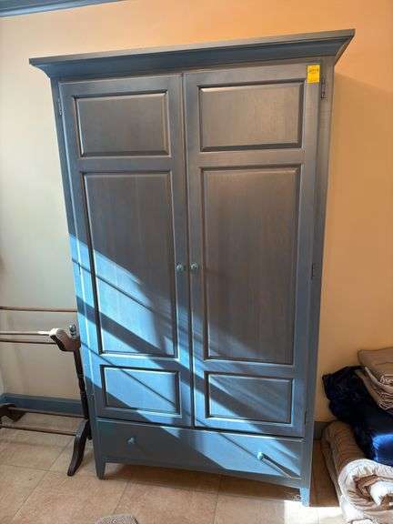 Impressions by Thomasville Armoire with interior shelving and drawers plus bottom drawer . In colonial blue. 44x74x14. Master bathroom. Master BR