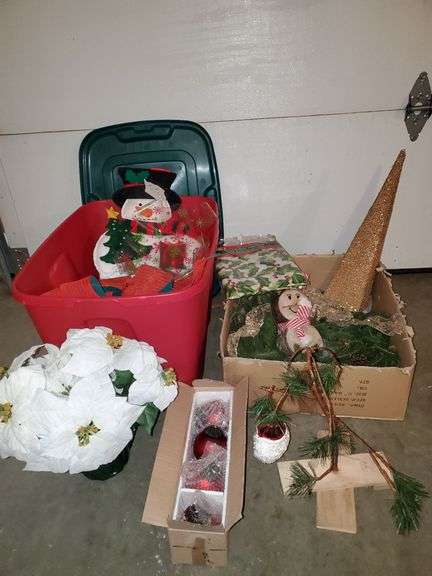 Christmas items including bows, snowman stocking, serving bowl, flannel back tablecloth, would snowman, 12-in wreath, Charlie Brown Christmas tree, ornaments and more. Includes tote with lid.