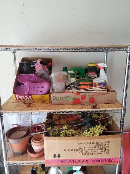 (2) shelf lot of gardening items including Miracle-Gro fertilizers, size 9 Garden Crocs, work gloves, planting pots, spring wreath, outdoor welcome flag. Garage