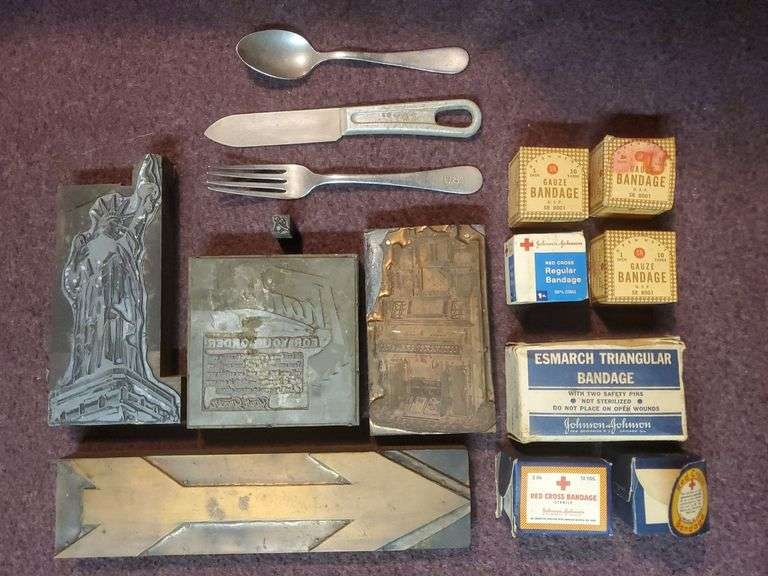 Copper and wood printing blocks, knife spoon fork marked U.S. Silicone Stainless, vintage gauze bandage boxes. Basement.