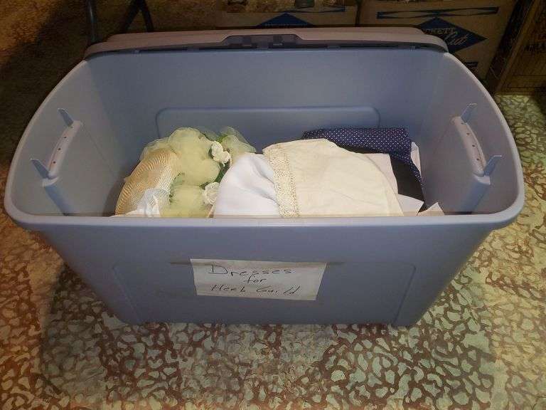 Large tote with lid marked dresses for herb guild. Basement