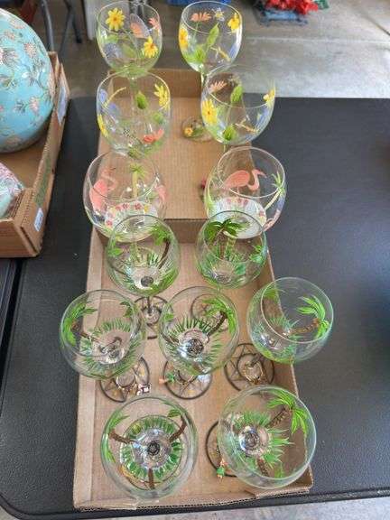 12 wine glasses, including four with dragonfly theme, two flamingo and six palm tree