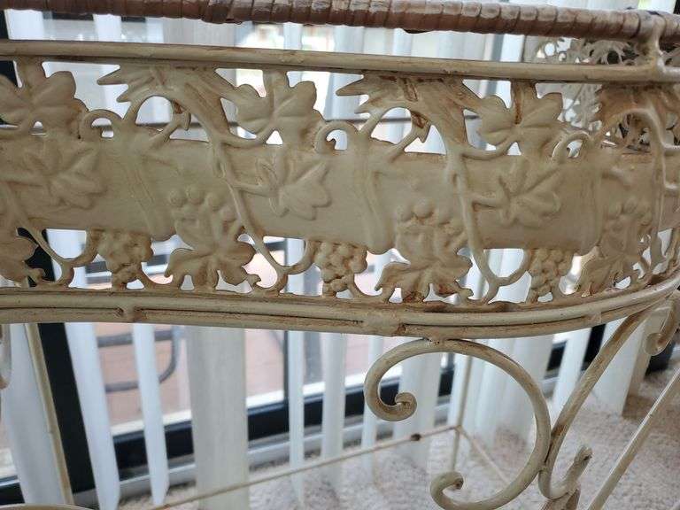 Wicker top and wrought iron framed plant stand with tropical runner measures 26 in WX 29 in H. Sunroom.