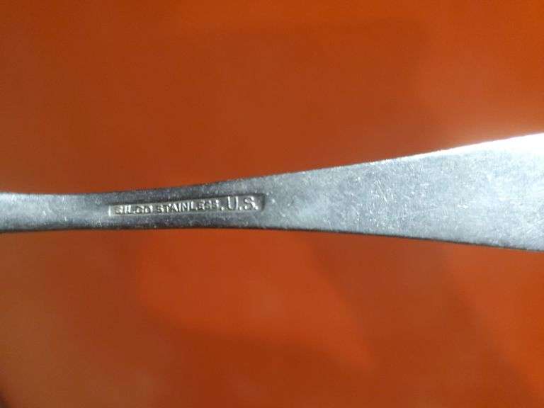Copper and wood printing blocks, knife spoon fork marked U.S. Silicone Stainless, vintage gauze bandage boxes. Basement.