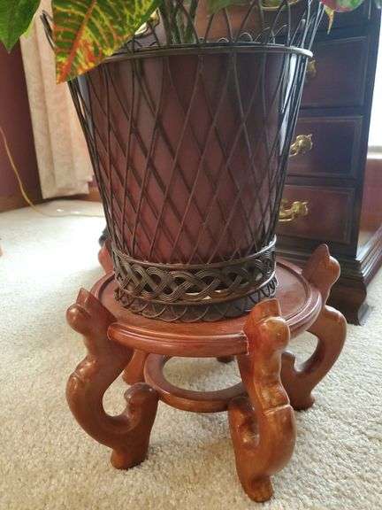 2 artificial plants in ornate planters, one with wood stand. Living room