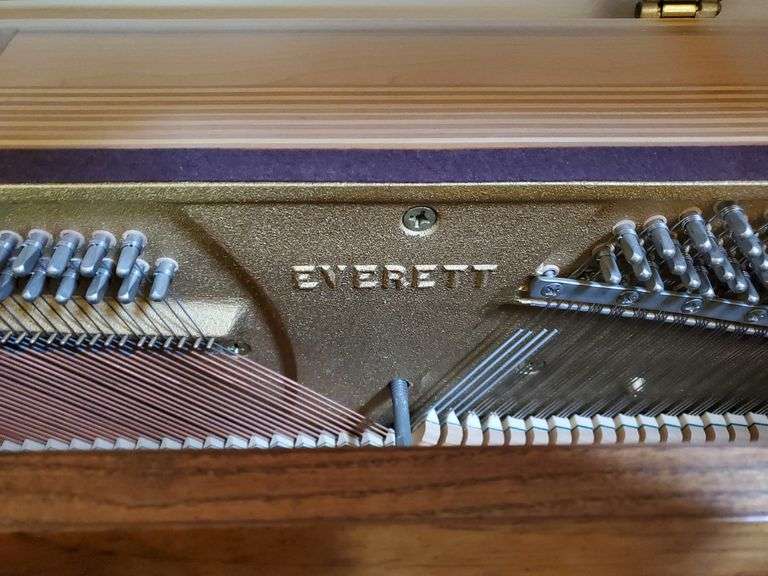 Vintage Everett piano with wood case designed by William g Faber. Measures 60 in wx 25 in DX 41 in H and includes lift top. living room