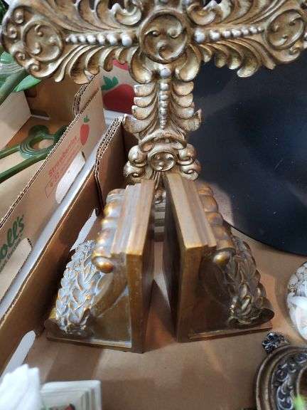 (2) box lot including (2) ceramic angel figurines, pillar candle holders, decorative crucifix, butterfly love stone, quartz mantle clock, ceramic teapot and heart-shaped trinket box. Garage
