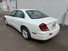 2001 Oldsmobile Aurora 4 dr. sedan, 3.5 L V6 engine, auto trans, full power including power windows, driver side power adjustable seat, beige leather seats, luster white exterior, only 27,572 miles!  See photos!   Runs and drives like new!  Payment in full by cash, certified check, or wire transfer payable to Basinger Auction Service at time of pickup on days noted.