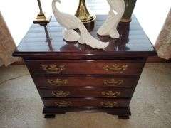 Hammery drop leaf Queen Anne style end table measures 19 in WX 28 in DX 26 in H and features single drawer. Hamry Chippendale style nightstand with four drawers. No contents stand only. Measures 24 in WX 15 in DX 24 in H. No contents. Stand only Living room.