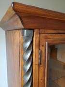 Beautiful solid wood entertainment center featuring beveled edged glass on doors, twisted metal accents in antique bronze finish, glass shelves with overhead lights, and plenty of storage, measures 108 in wide 24 in D X 74 in h. Breaks down into approximately five pieces. Family room.