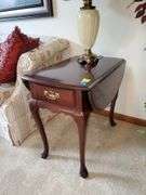 Hammery drop leaf Queen Anne style end table measures 19 in WX 28 in DX 26 in H and features single drawer. Hamry Chippendale style nightstand with four drawers. No contents stand only. Measures 24 in WX 15 in DX 24 in H. No contents. Stand only Living room.