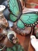 (2) box lot including (2) ceramic angel figurines, pillar candle holders, decorative crucifix, butterfly love stone, quartz mantle clock, ceramic teapot and heart-shaped trinket box. Garage