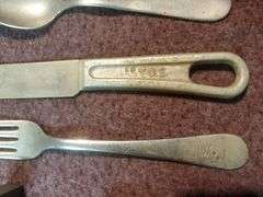 Copper and wood printing blocks, knife spoon fork marked U.S. Silicone Stainless, vintage gauze bandage boxes. Basement.