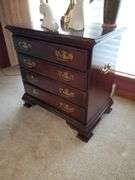 Hammery drop leaf Queen Anne style end table measures 19 in WX 28 in DX 26 in H and features single drawer. Hamry Chippendale style nightstand with four drawers. No contents stand only. Measures 24 in WX 15 in DX 24 in H. No contents. Stand only Living room.