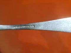 Copper and wood printing blocks, knife spoon fork marked U.S. Silicone Stainless, vintage gauze bandage boxes. Basement.