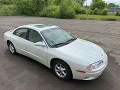 2001 Oldsmobile Aurora 4 dr. sedan, 3.5 L V6 engine, auto trans, full power including power windows, driver side power adjustable seat, beige leather seats, luster white exterior, only 27,572 miles!  See photos!   Runs and drives like new!  Payment in full by cash, certified check, or wire transfer payable to Basinger Auction Service at time of pickup on days noted.