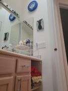 Bath Towels, Hand Towels, Wire Organizer Stand with contents, Ceramic Wall art, and Crestor Wall Clock