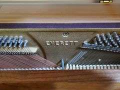 Vintage Everett piano with wood case designed by William g Faber. Measures 60 in wx 25 in DX 41 in H and includes lift top. living room
